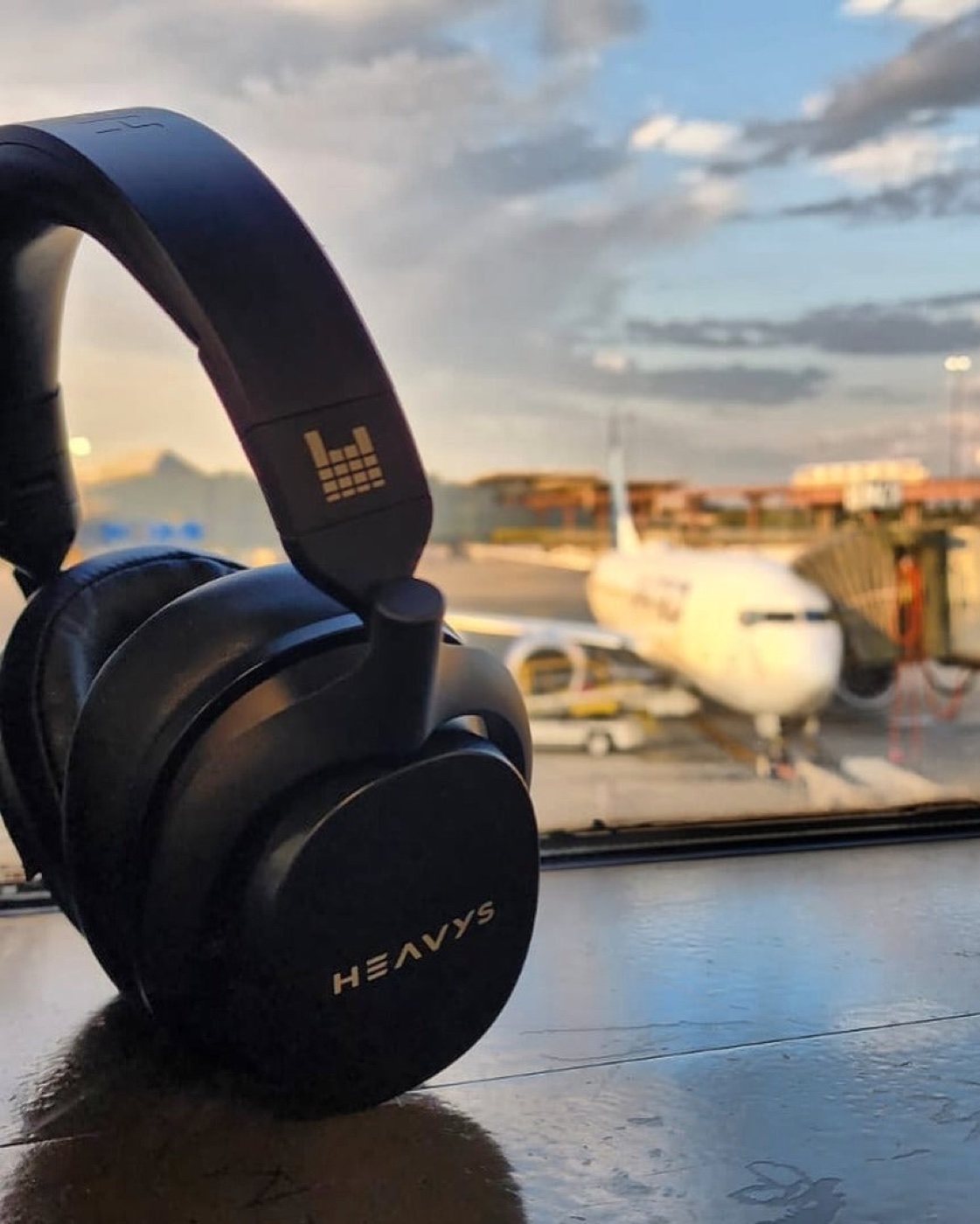 Heavys H1H headphones at an airport gate at sunset